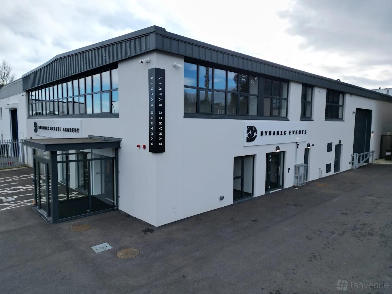 A two-story event hall with large windows and prominent signage at Dynamic Space Events.