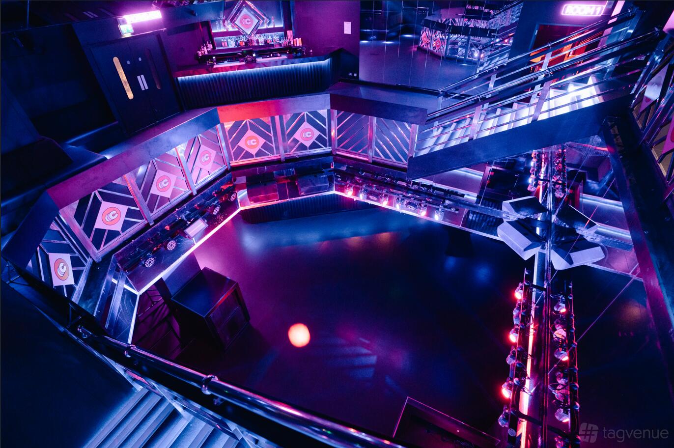 A nightclub event space with neon purple lighting, geometric wall patterns, and a mezzanine at Circuit Kingston Upon Thames.