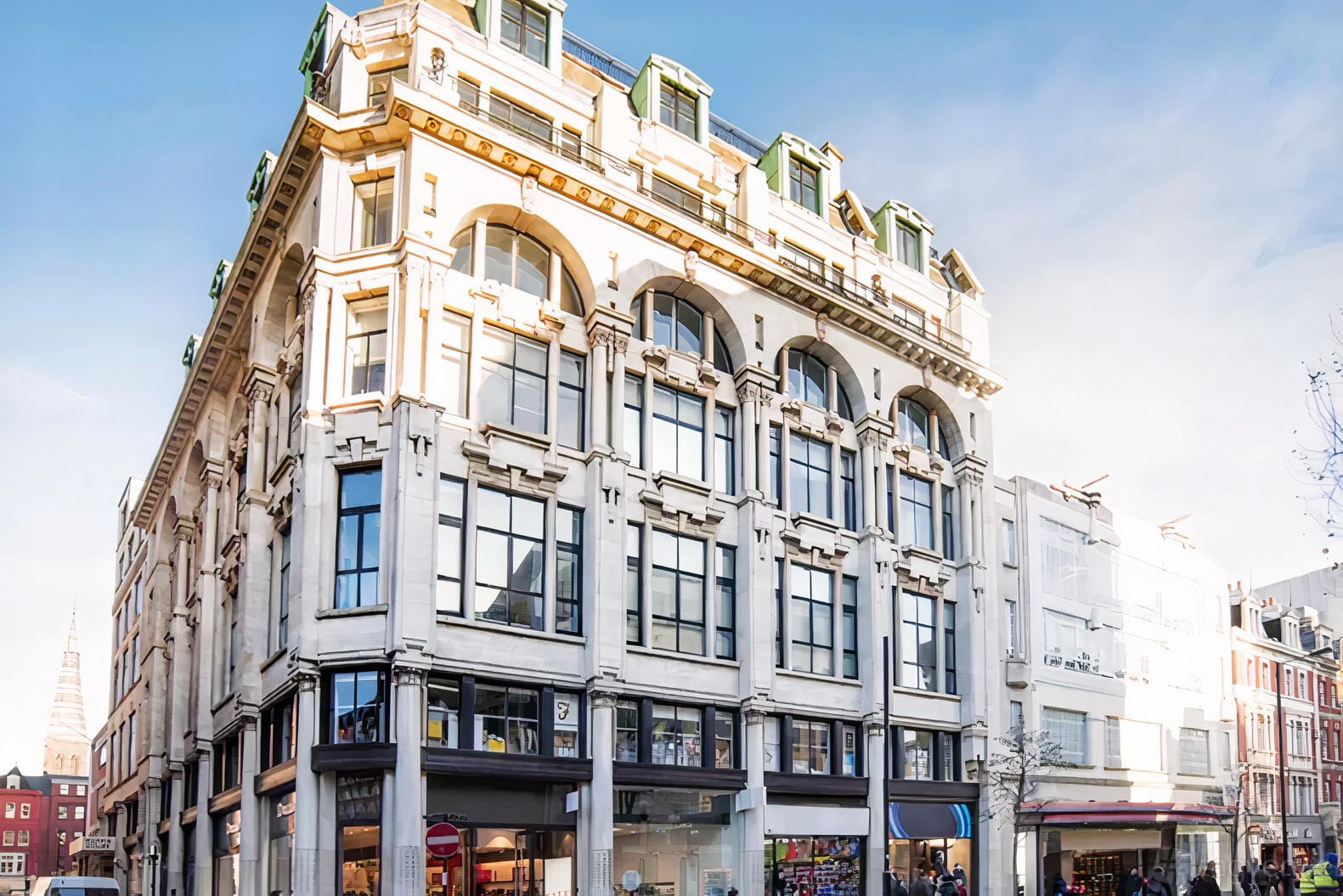 A meeting centre in a historic multi-story building with large arched windows at Spaces - London, Spaces Oxford Street.