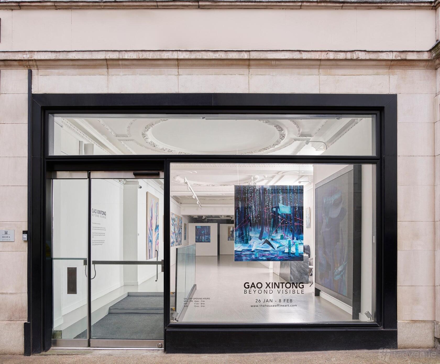 A gallery with large front windows, white walls, and contemporary artwork on display at WHITE SPACE MAYFAIR.