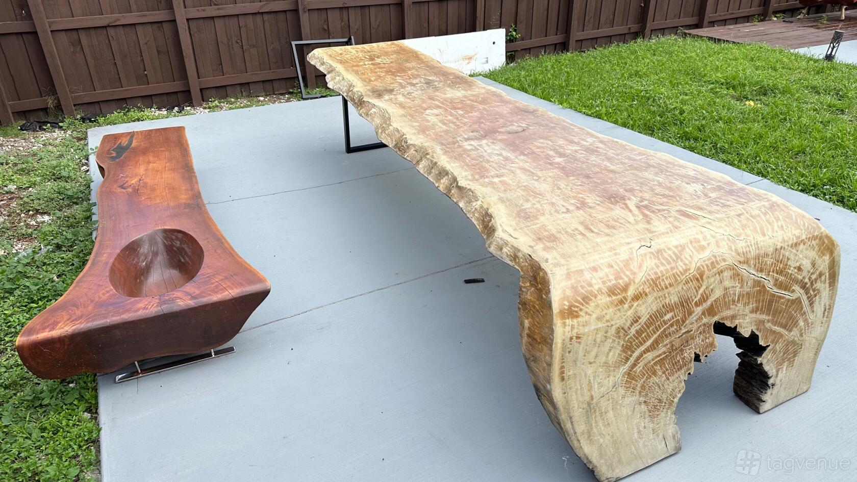 An outdoor venue garden with a large live-edge wooden table and matching bench at Charming North Miami Outdoor Oasis with Pool.