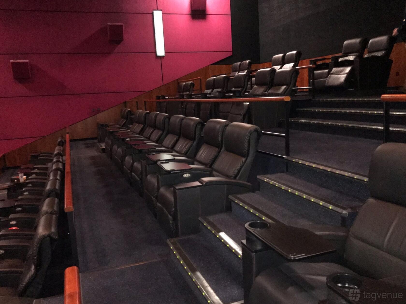 A cinema with tiered leather recliner seating and built-in trays at Vue Birmingham - Star City.