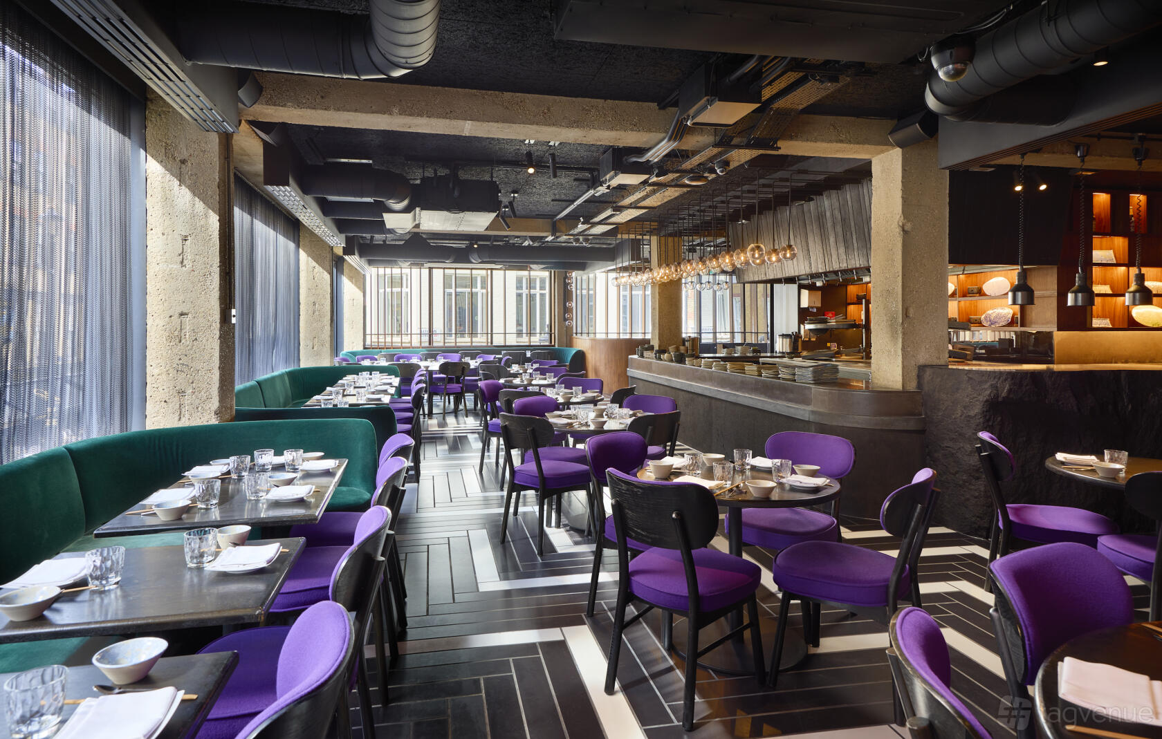 A dining room with purple chairs, green banquette seating, and floor-to-ceiling windows at Chotto Matte.