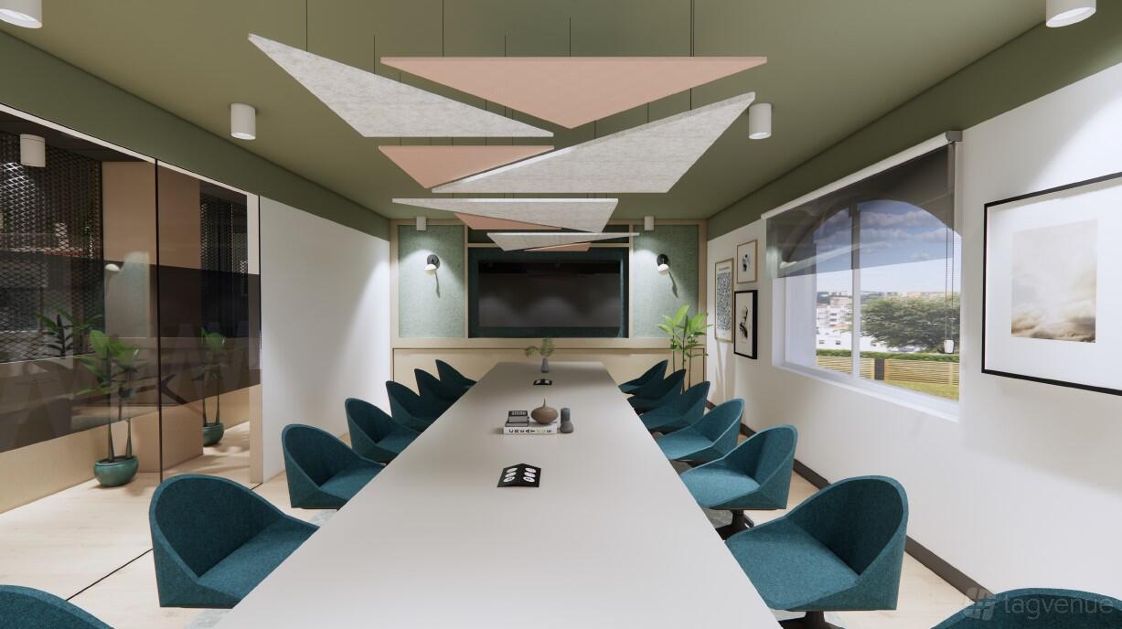 A meeting centre with a long conference table, teal chairs, geometric ceiling panels, and large windows at East Coast House.