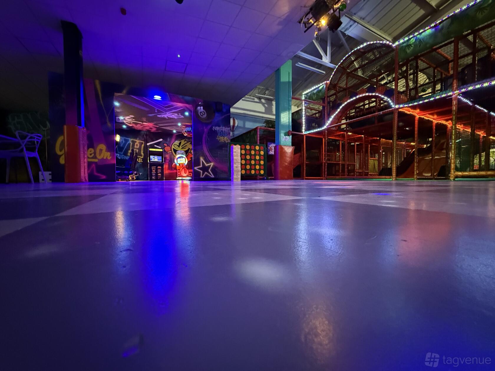 An event venue with a colorful indoor playground, arcade games, and glossy flooring at Northants Venue Hire.