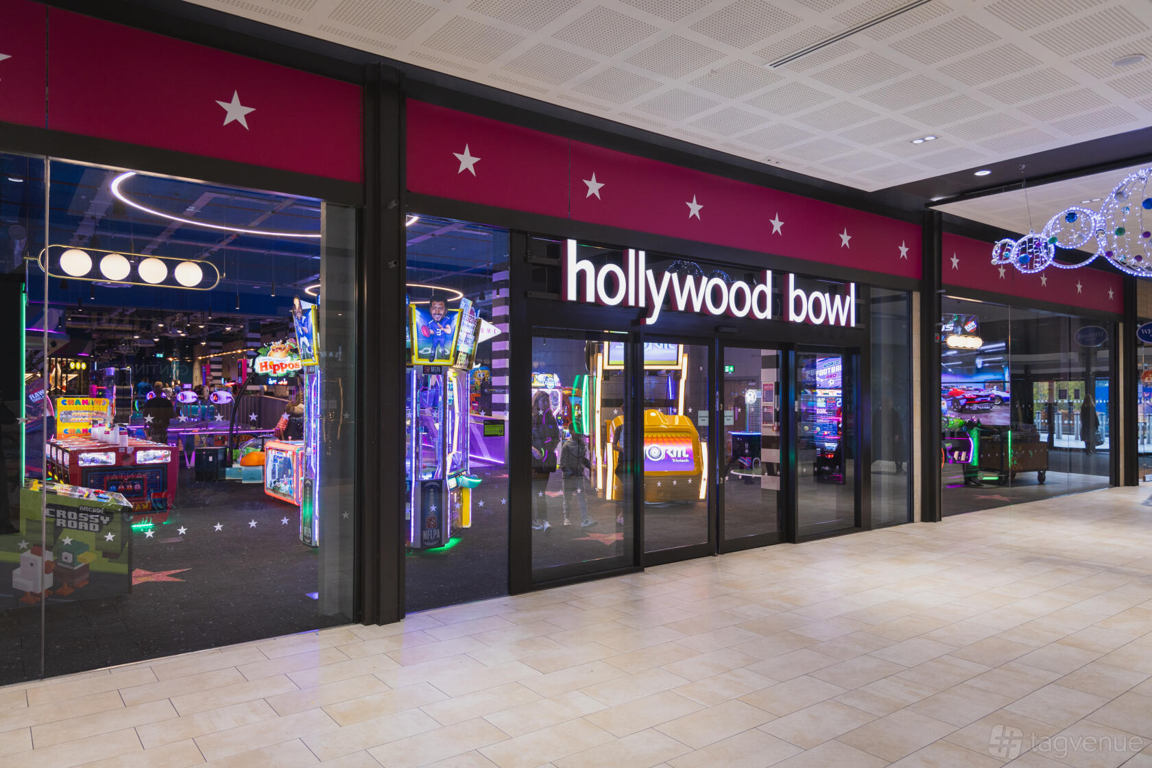 A versatile event space with arcade games and bright signage at Hollywood Bowl Birmingham Resorts World.