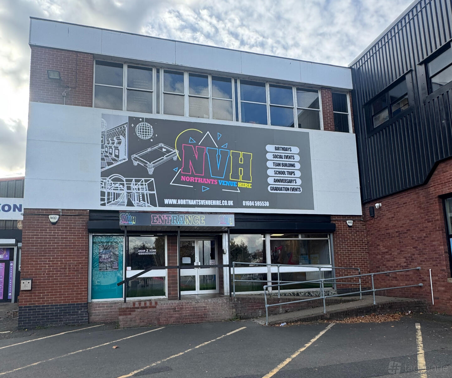 A brick and glass building with large signage for Northants Venue Hire above the main entrance.
