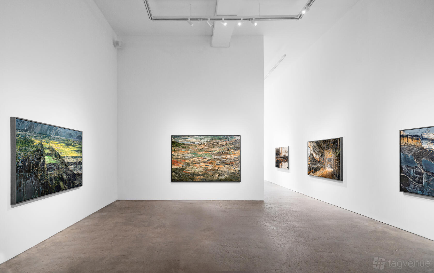 A spacious gallery with white walls, polished concrete floors, and large landscape paintings at Heft Gallery.