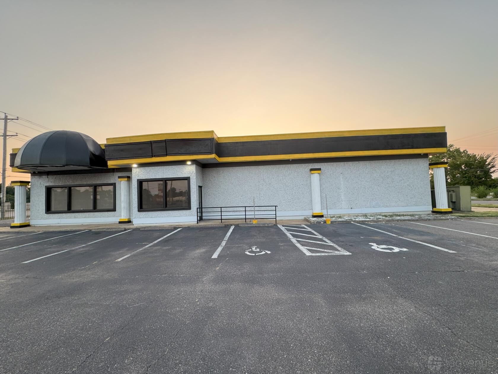 A hall with a flat roof, accessible ramp, and dedicated handicapped parking at CHARLO EVENT CENTER.