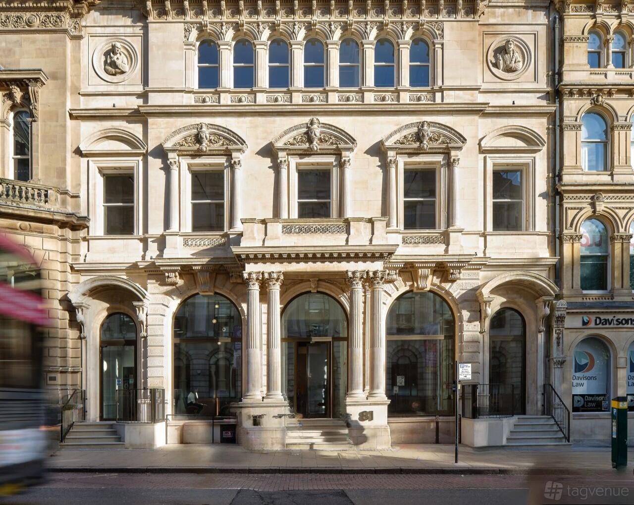 A coworking space with an ornate stone facade, arched windows, and pillars at 81 Colmore Row