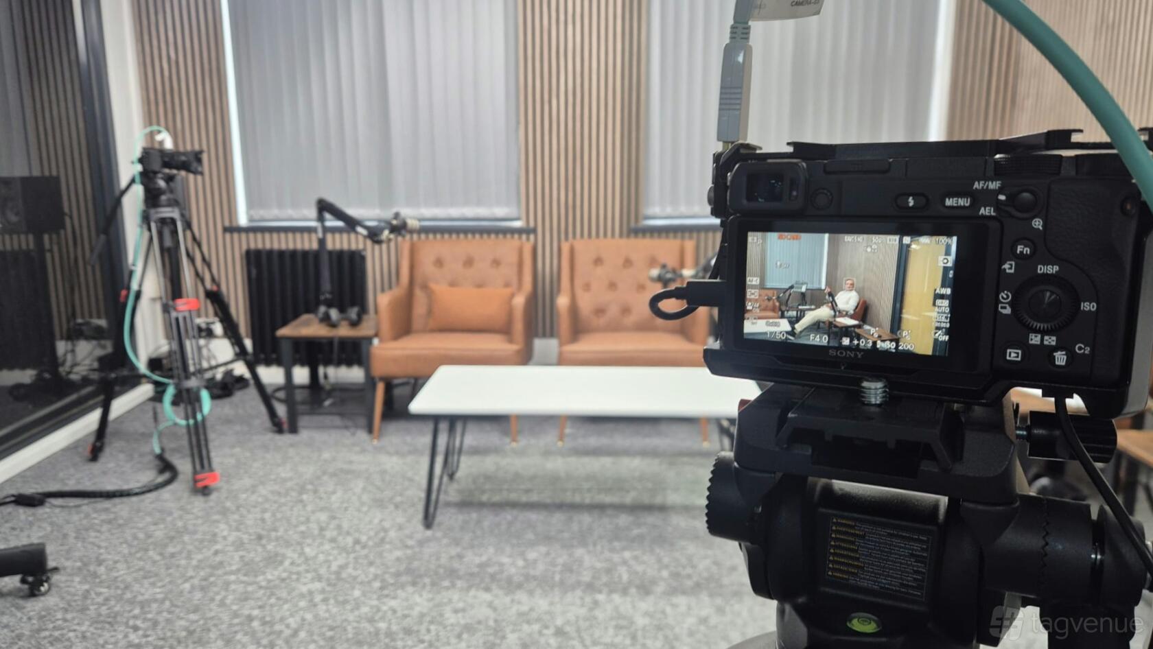 DM Studios podcast room with camera and recording setup