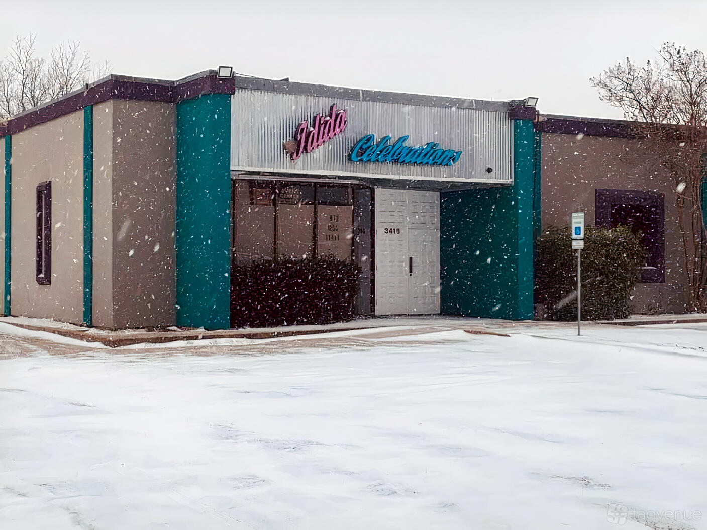 A single-story hall with teal accents, corrugated metal facade, and snow-covered entrance at Idida Celebrations Venue.