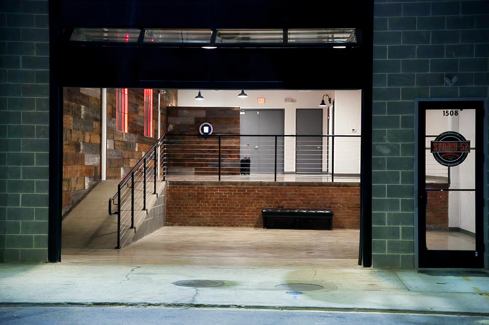 A versatile event space with wood-paneled walls, exposed brick, and an industrial ramp at Studio 52.