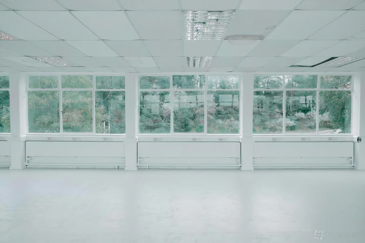 An event venue with large windows, white walls, and natural light at PINK.