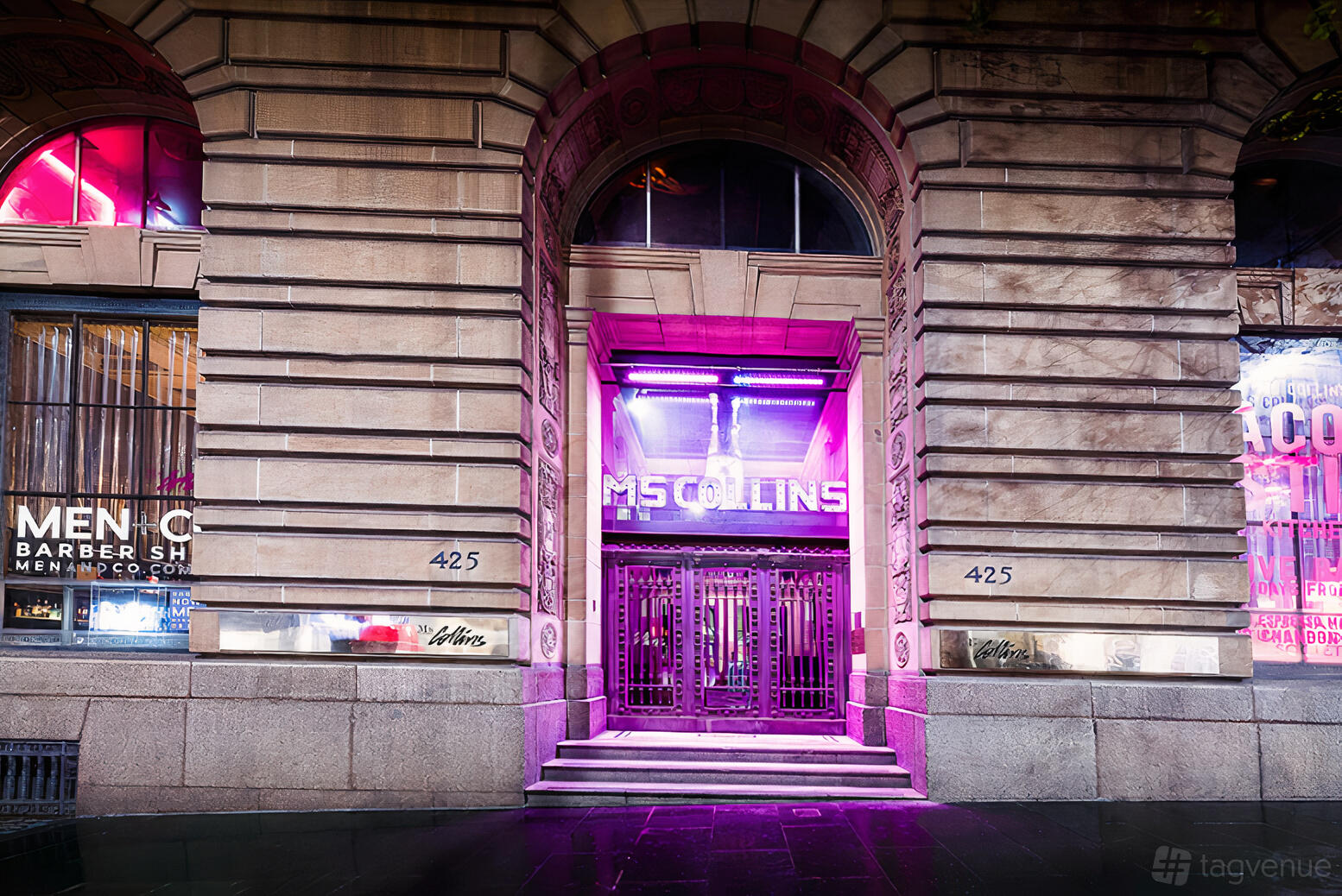 An event space entrance with neon purple lighting and tall ornate doors at Ms Collins.