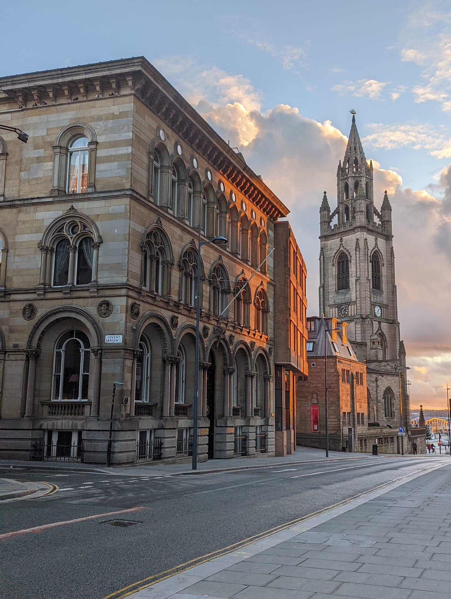 A historic hotel with arched windows and ornate stone facade at Racquet Club Hotel & Ziba Restaurant.