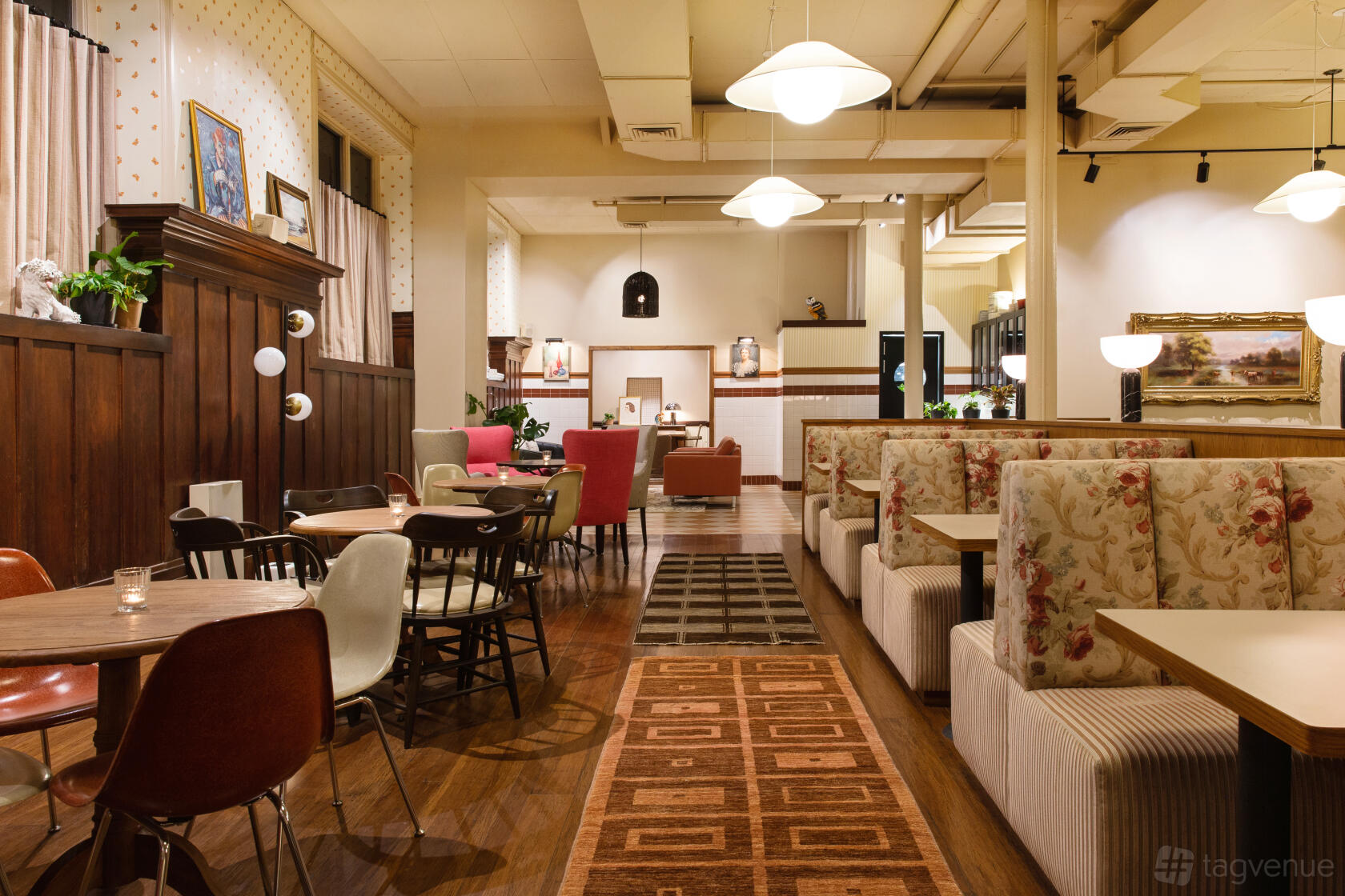 A hotel dining room with patterned booths, wood paneling, and pendant lighting at Palihotel San Francisco.
