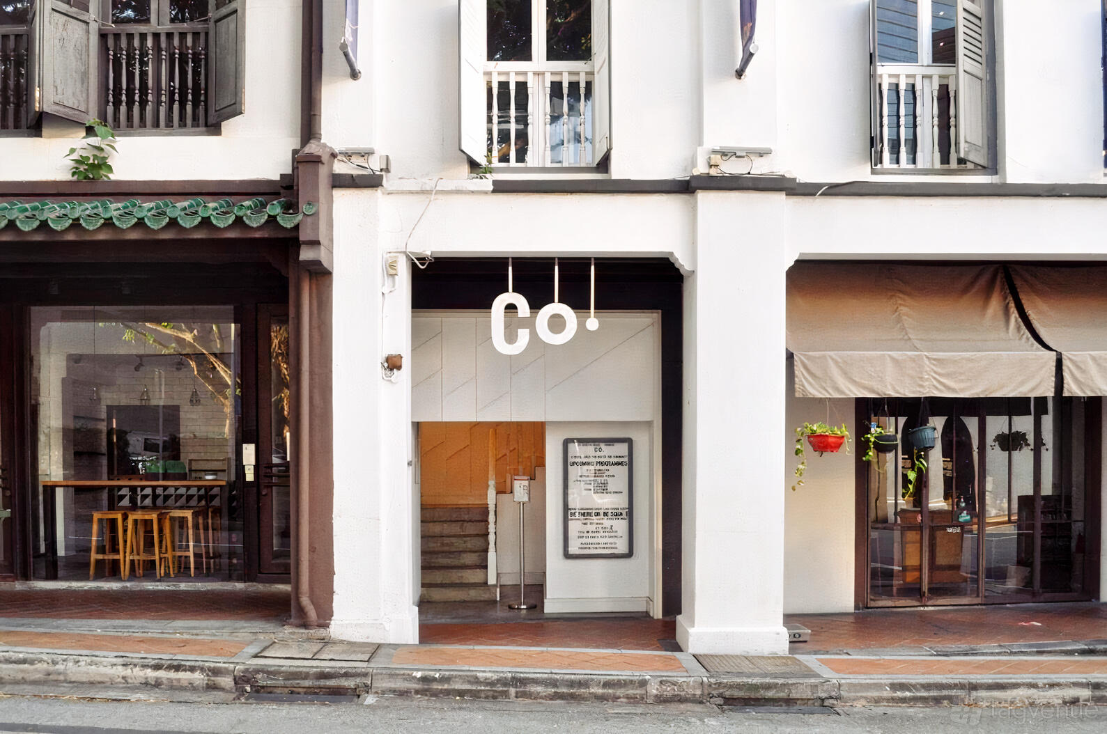 A versatile event space with a white facade, large windows, and minimal signage at the Co. at Duxton.