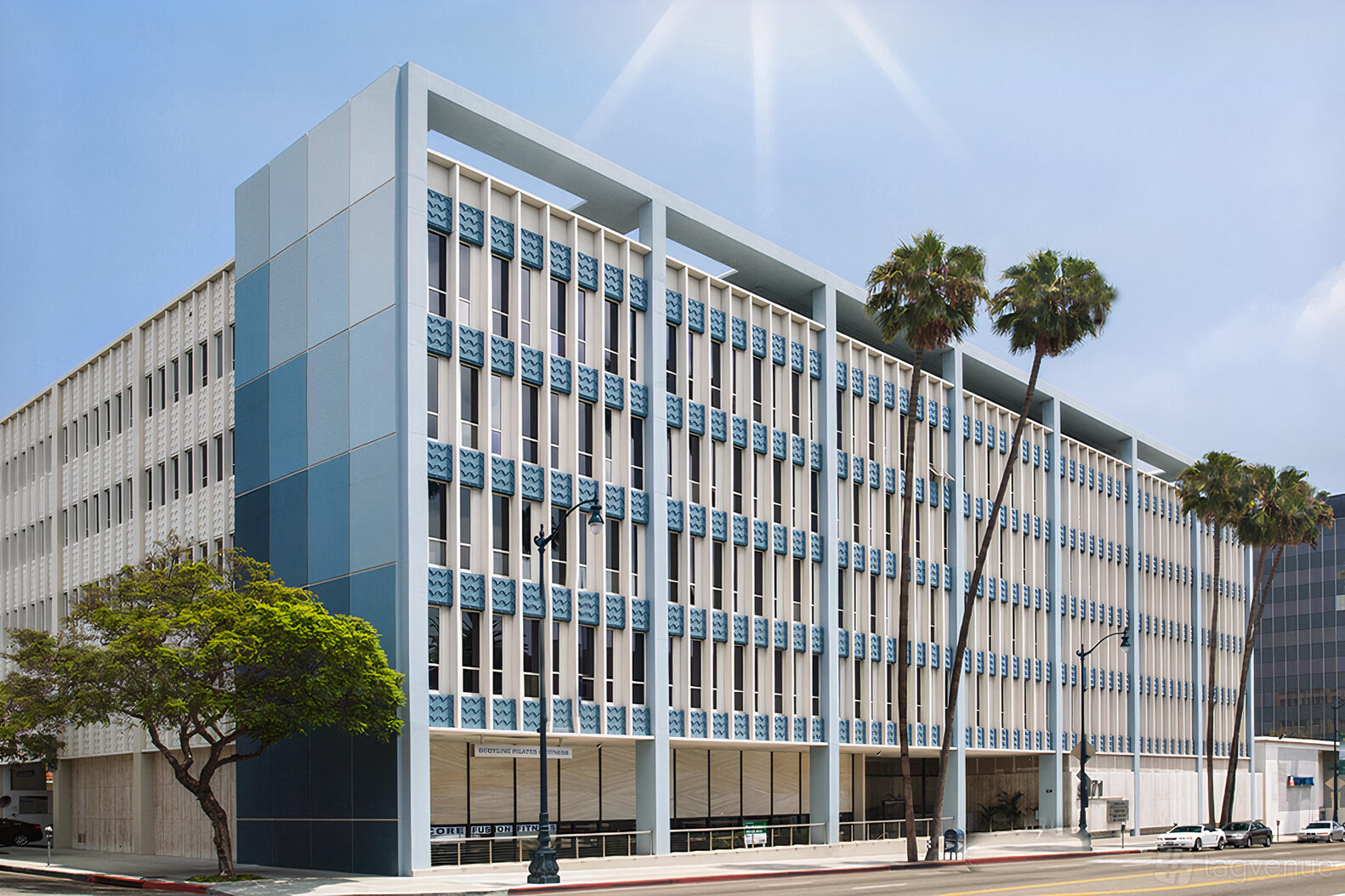 An office building with geometric blue and white facade, palm trees, and street view at Premier Workspaces - Beverly Hills.