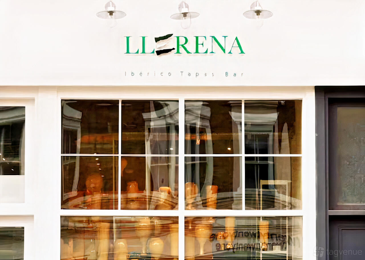 A restaurant exterior with large windows and the Llerena Tapas Bar sign above the entrance.