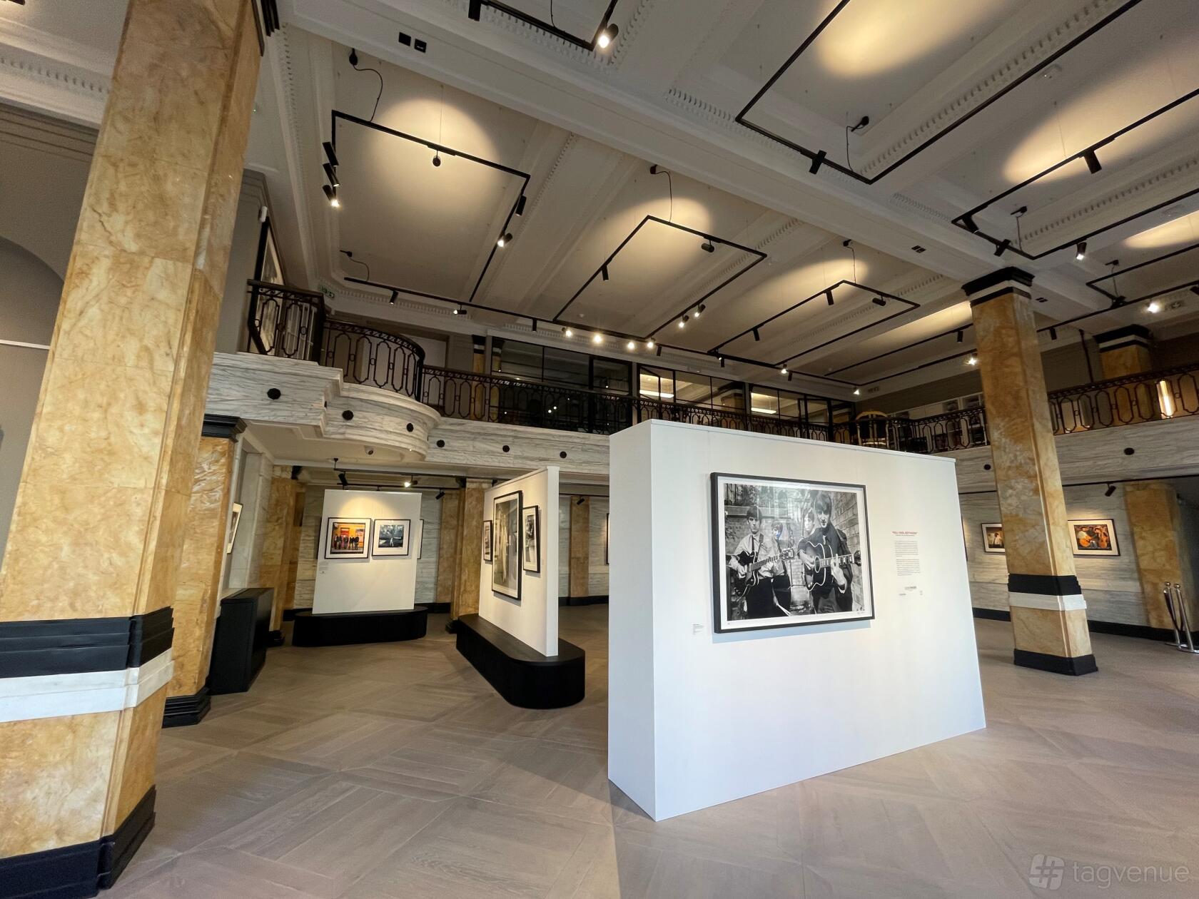 A gallery with marble columns, high ceilings, and framed photographs on display at Iconic Images Gallery, Piccadilly.