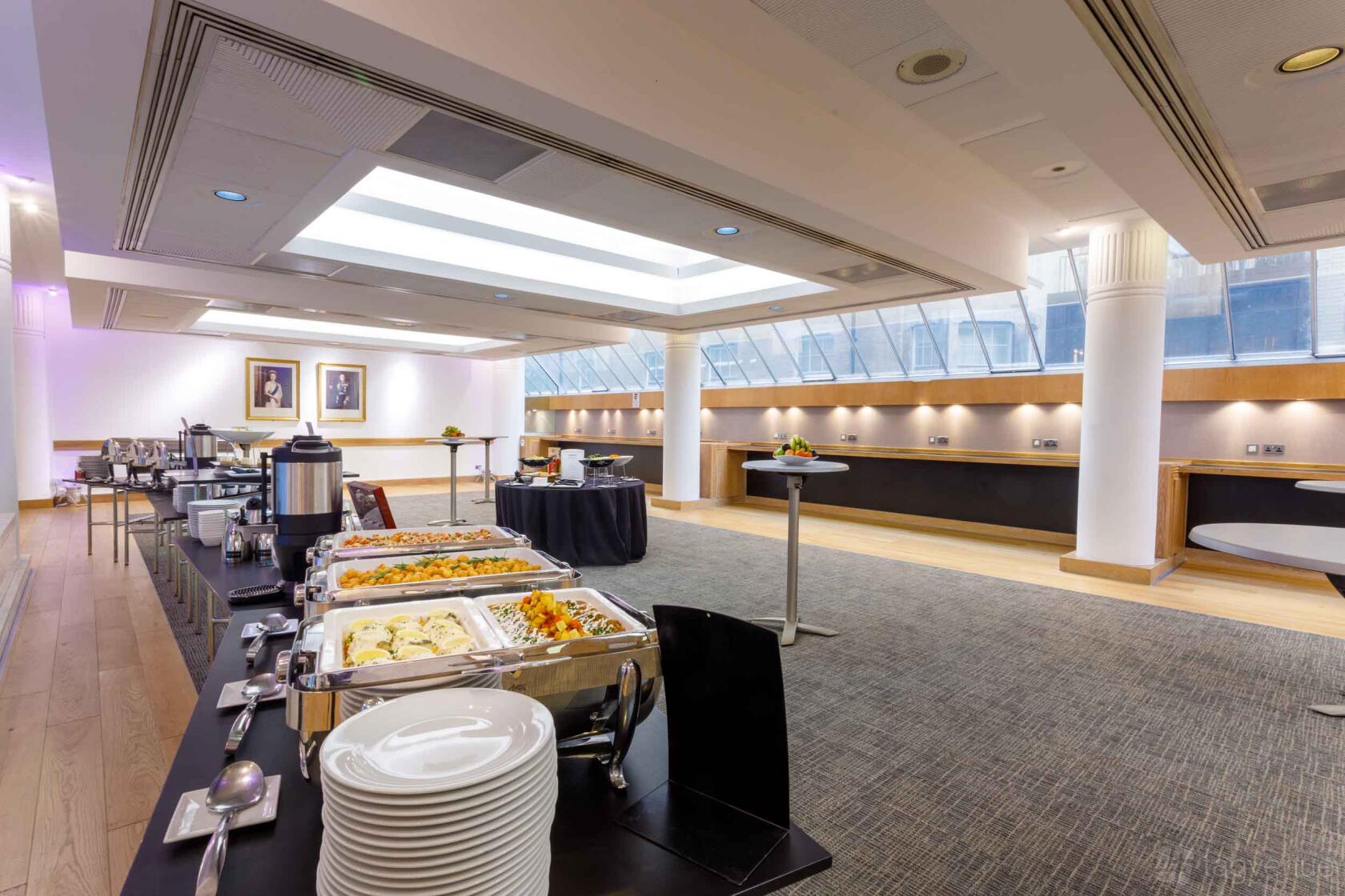 An event venue with skylights, catering buffet tables, and framed portraits at 1 Wimpole Street.