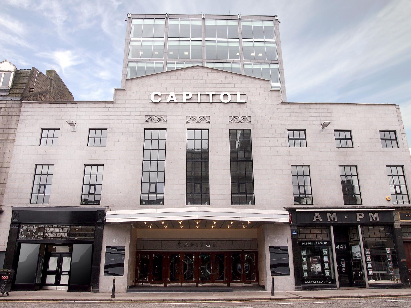 An office building with a light stone façade, tall windows, and CAPITOL lettering at Orega Aberdeen.