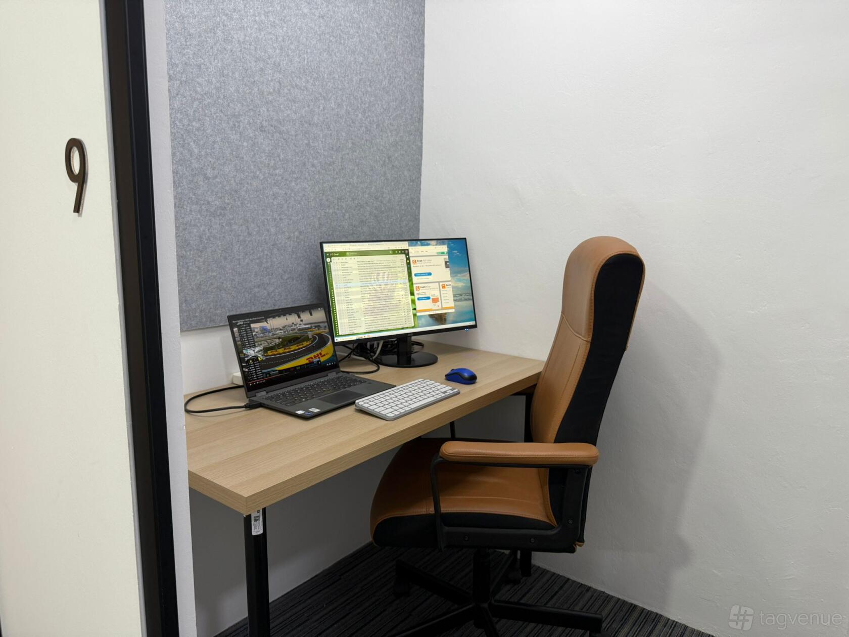 A coworking space with a private office featuring a desk, computer monitor, laptop, and ergonomic chair at Cosy Corner.