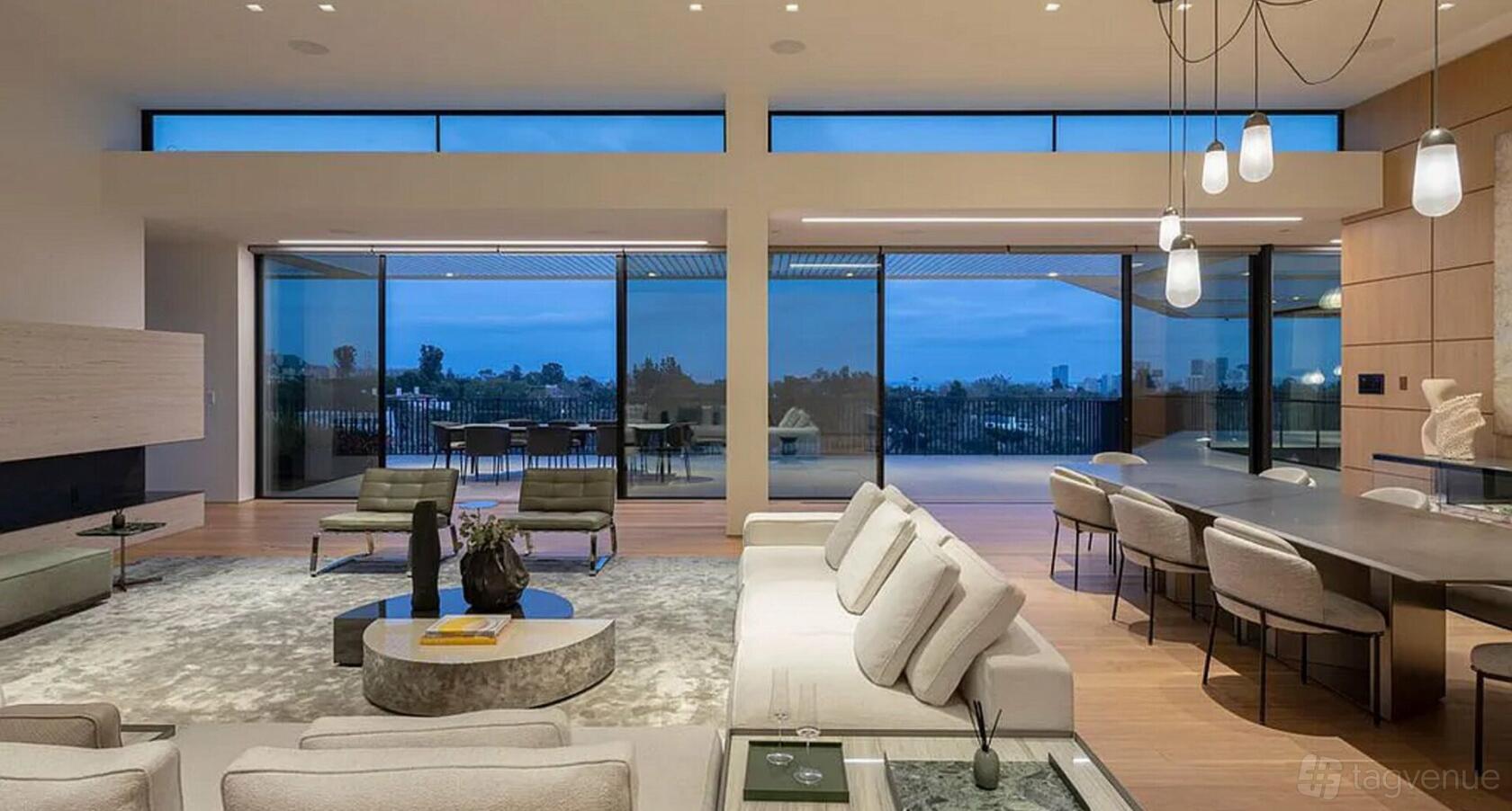 An event venue with floor-to-ceiling windows, modern furnishings, and an open layout at The Siena Villa.