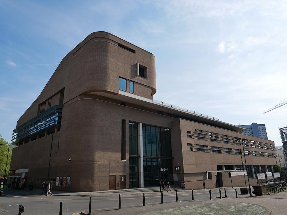 A versatile event space with a curved brick exterior and large glass entrance at Stoller Hall.