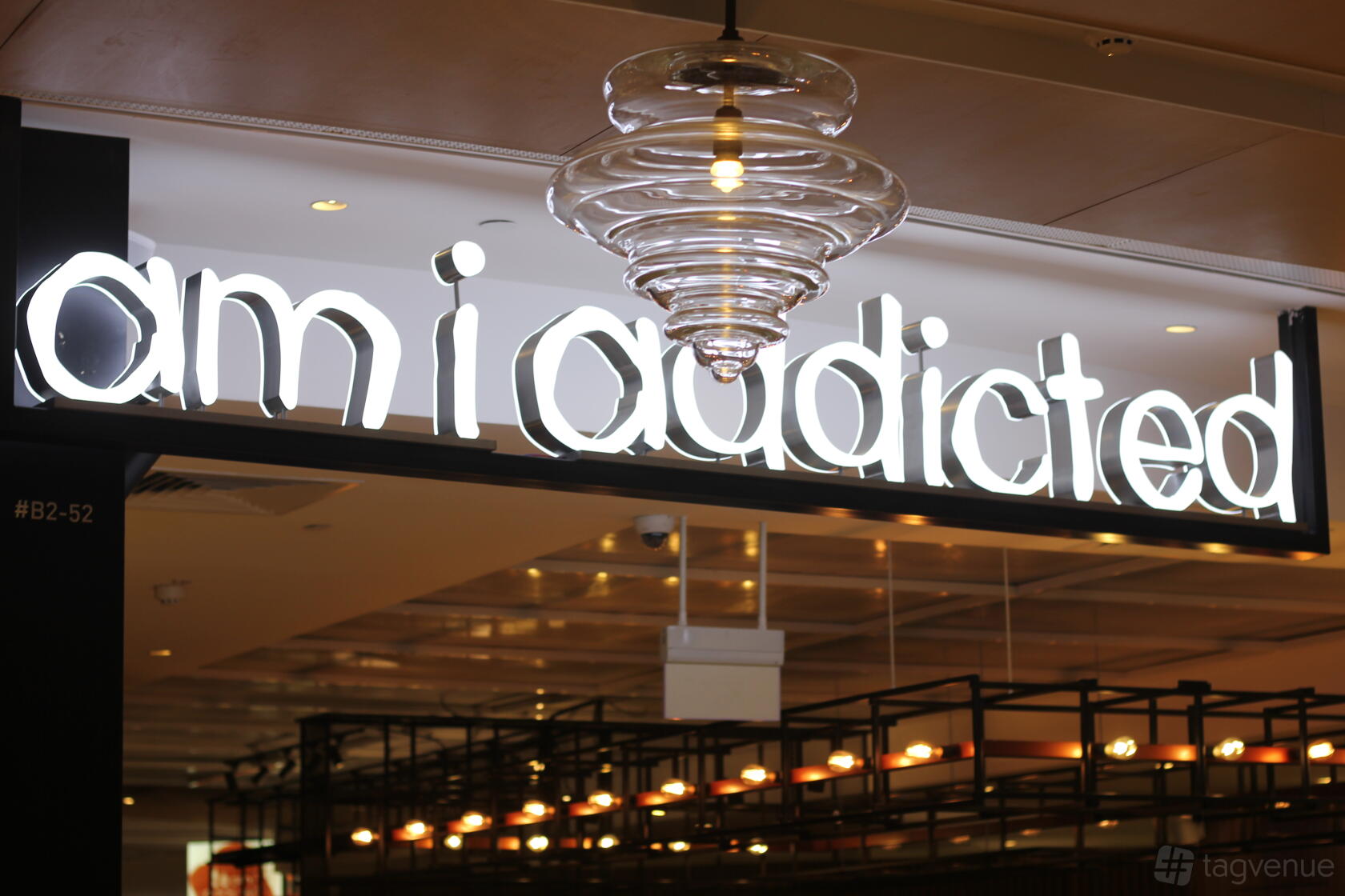 A versatile event space with a neon studio sign and glass pendant lighting at Am I Addicted Korean Pottery Studio.