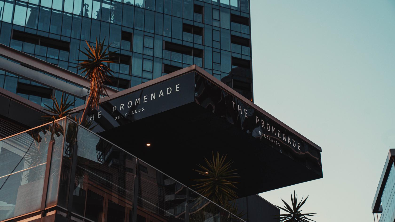 An event venue with a black canopy entrance and glass panels at The Promenade Docklands.