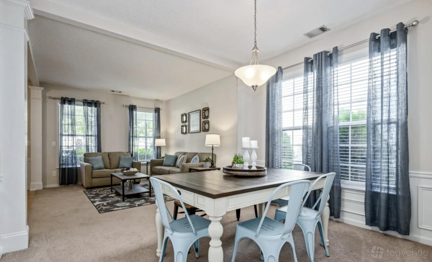 A house with a bright open-plan living and dining area, large windows, and contemporary furnishings at Suite Stays Atlanta - Persimmon Trail.