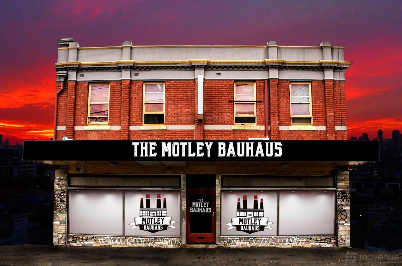 A versatile event space in a red brick building with large windows and prominent signage at The Motley Bauhaus.