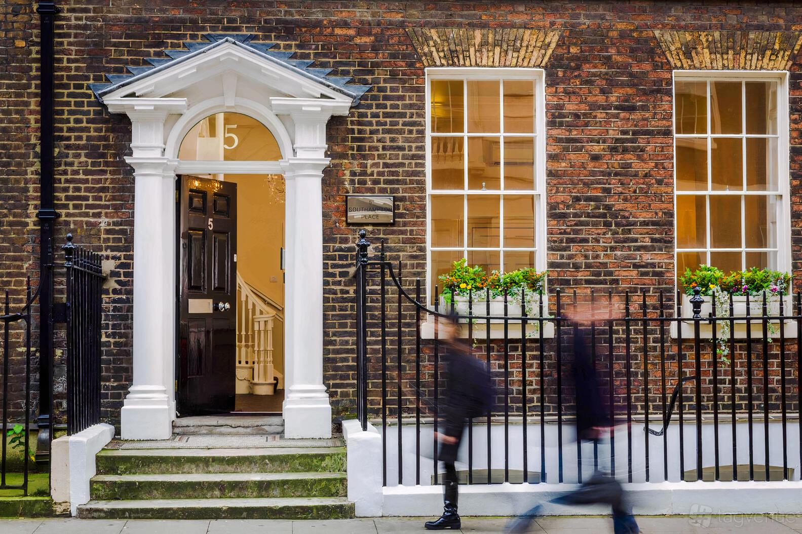 A meeting centre with a Georgian brick facade, arched entryway, and window planters at Southampton Place.