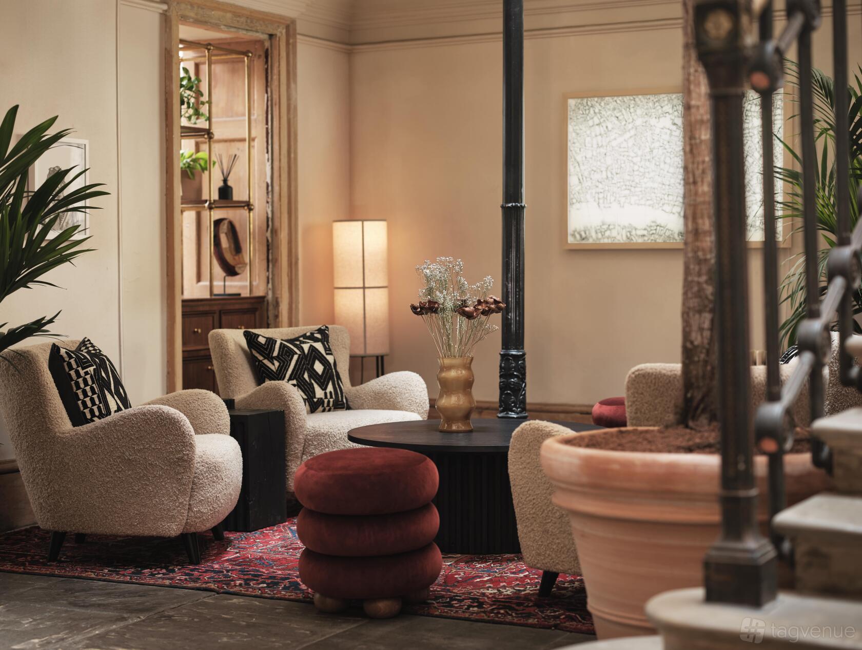A grand, historic room with ornate woodwork and large windows, reminiscent of the elegant settings in Outlander’s 18th-century scenes