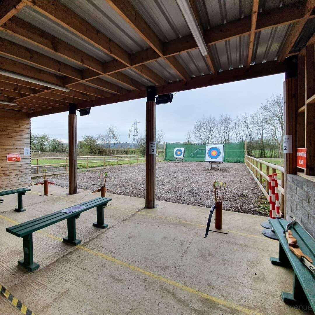 An archery range with target boards, gravel ground, and benches at Windmill Leisure Golf & Activity Centre.