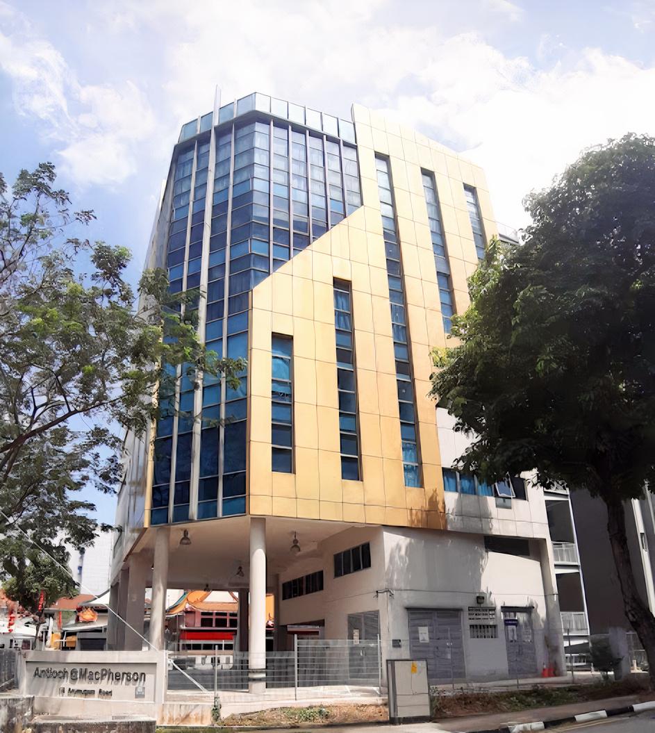 A multi-story event venue with gold and blue glass facade and large geometric windows at Advance Vision.