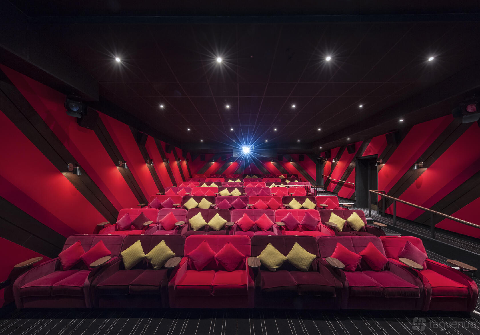 A screening room with plush red armchairs, colorful cushions, and a star-lit ceiling at Everyman Newcastle.