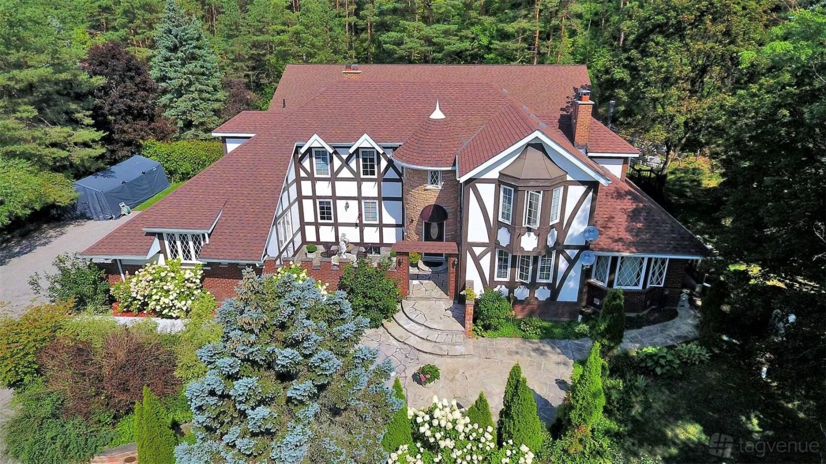 A Tudor-style event venue with half-timbered exterior, red roof, and landscaped gardens at Vivian Events & Spa.