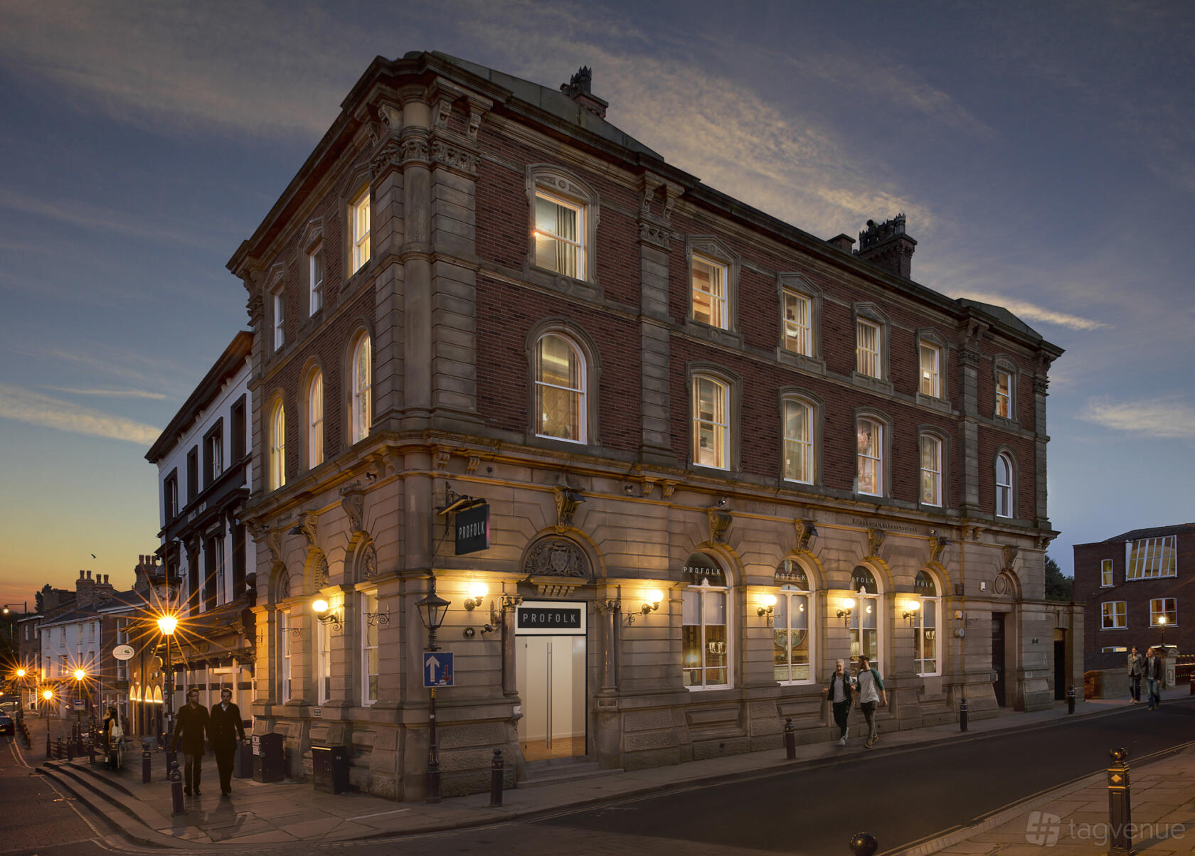A historic meeting centre with large arched windows and illuminated exterior at PROFOLK.