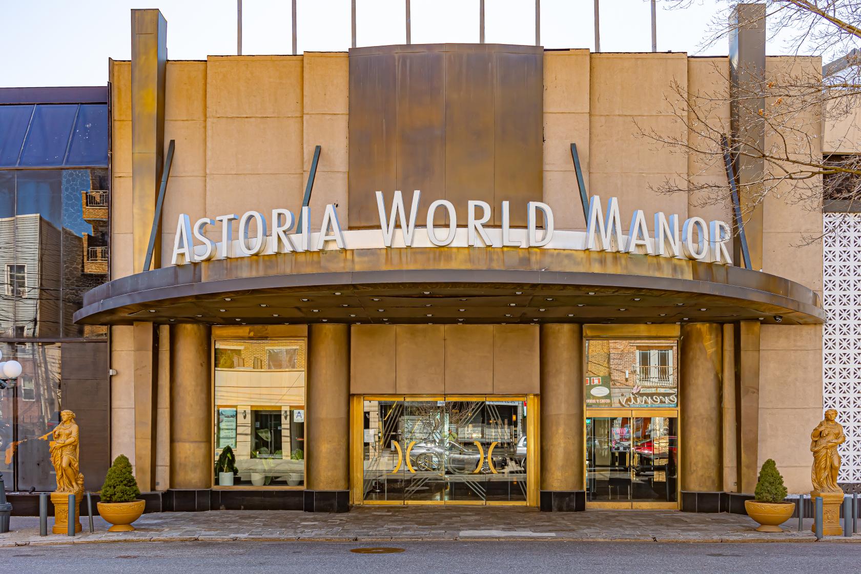 An event space entrance with large marquee lettering, gold accents, and statues at Astoria World Manor.