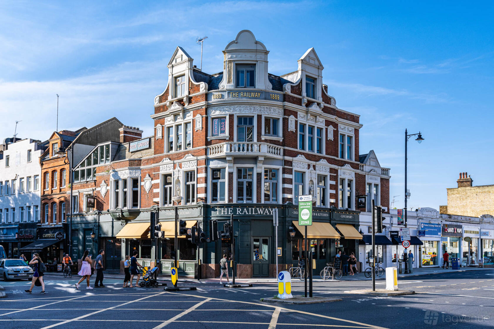 A Victorian-style pub with red brick facade, large windows, and corner entrance at The Railway.