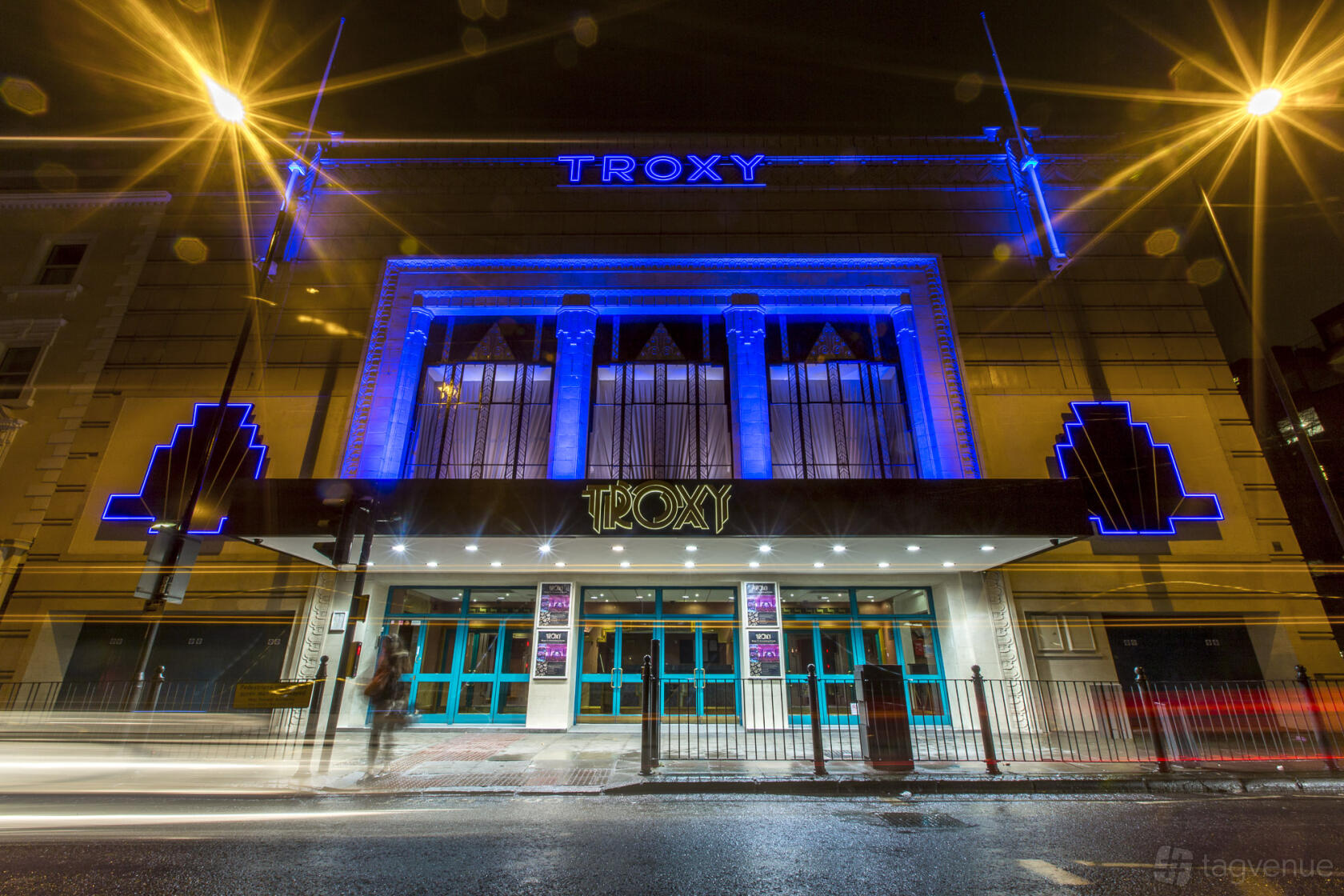 An art deco event venue with a neon-lit facade and marquee entrance at Troxy.