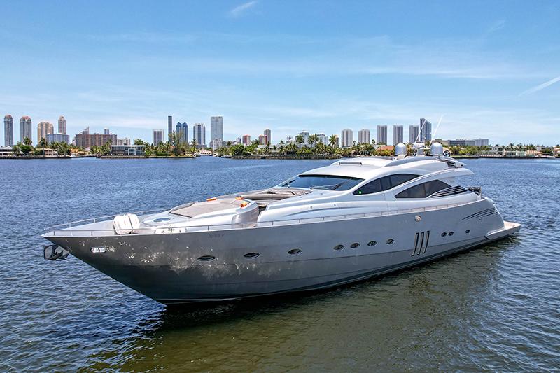 A sleek silver yacht with sun loungers on the deck, shown on open water at Jerico Yacht Charters.