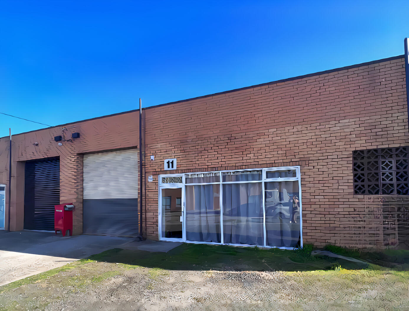 A brick exterior with a glass door entrance and roller garage door at Bentleigh Calisthenics Studios.