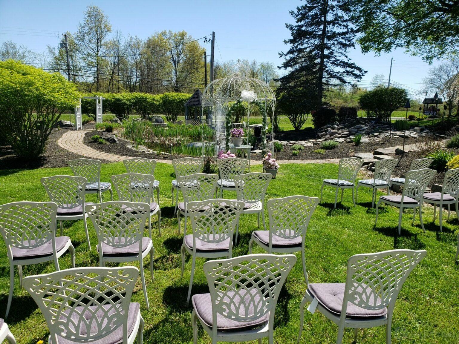 An outdoor event lawn with white chairs arranged facing a decorative gazebo at Zanger Hall.