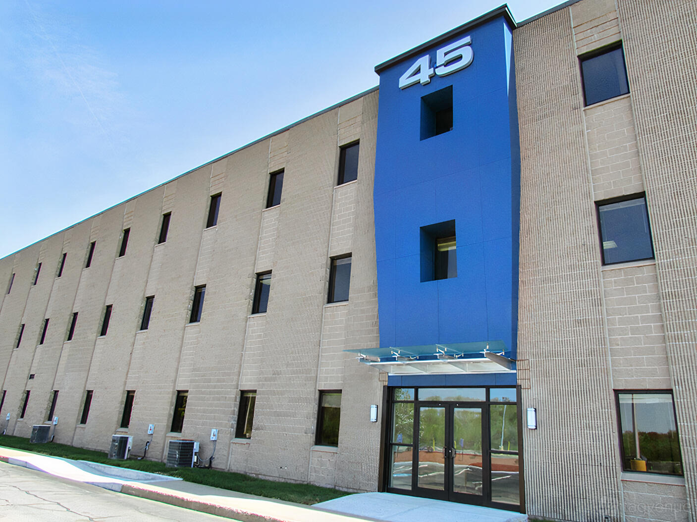 A meeting centre with a blue entrance facade and glass doors at Workspace@45.