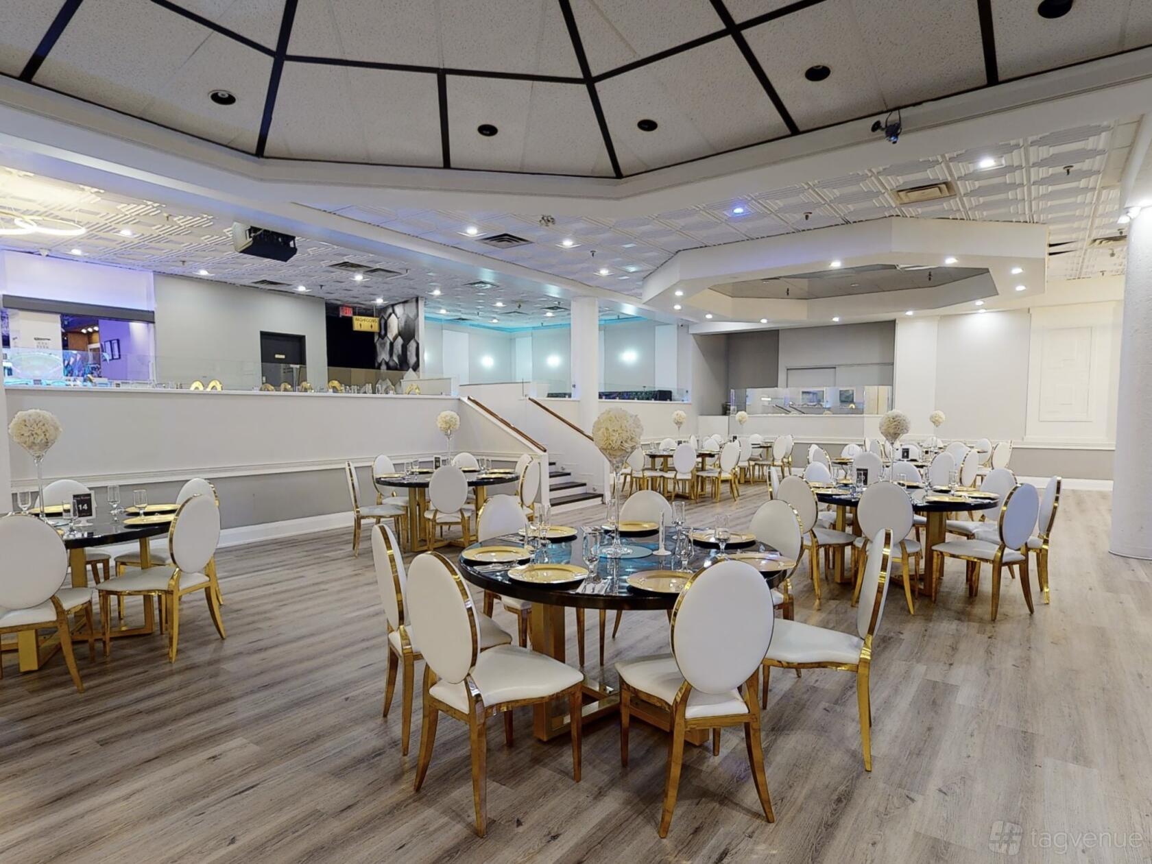 A banqueting hall with round tables and white chairs, wood flooring, and neutral decor at Star Nation.