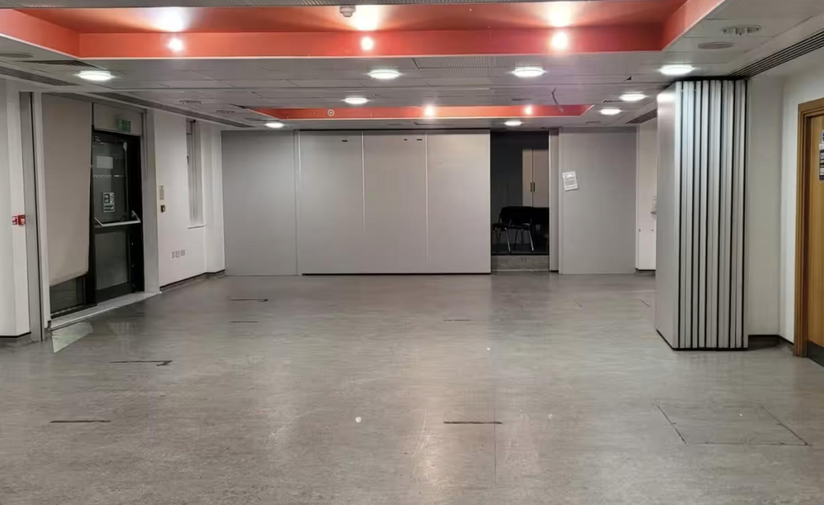 A spacious hall with a polished floor, folding partition walls, and ceiling lights at Harford Centre Main Hall.